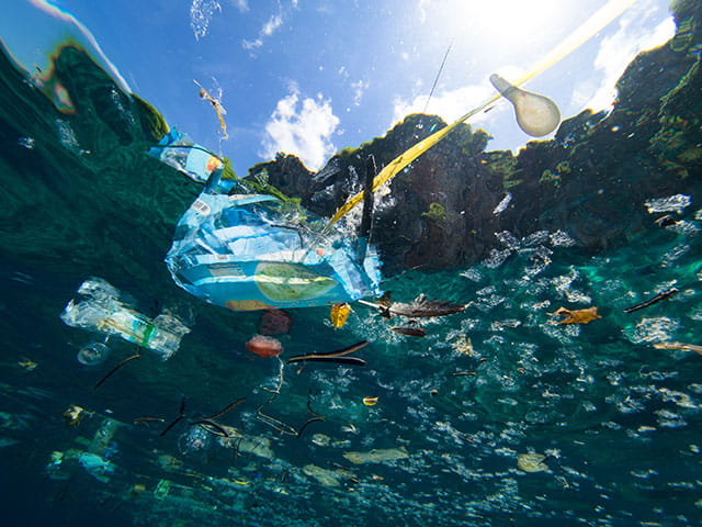 Floating plastic trash on the surface of the ocean